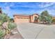 Well-maintained home with a spacious driveway and desert landscaping at 19973 N Monte Ln, Maricopa, AZ 85138