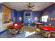 Spacious game room with multiple poker tables, blue walls, ample lighting, and room for entertainment at 19973 N Monte Ln, Maricopa, AZ 85138
