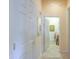 Hallway with linen closet leads to the laundry room with a stacked washer/dryer at 19973 N Monte Ln, Maricopa, AZ 85138