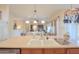 Bright and airy kitchen with a large central island, sink, and pendant lighting at 19973 N Monte Ln, Maricopa, AZ 85138