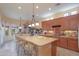 Large eat in kitchen with central island, hanging pot rack, and pendant lighting at 19973 N Monte Ln, Maricopa, AZ 85138