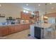 Spacious kitchen with large central island with seating and stainless steel appliances at 19973 N Monte Ln, Maricopa, AZ 85138