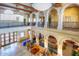 An open community center lobby with seating, plants and a second level balcony at 19973 N Monte Ln, Maricopa, AZ 85138