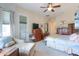 Spacious main bedroom boasts natural light, a ceiling fan, and comfortable seating at 19973 N Monte Ln, Maricopa, AZ 85138
