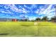 Expansive outdoor putting green with a bright flag, well-maintained grass, and outdoor lighting under a sunny sky at 19973 N Monte Ln, Maricopa, AZ 85138