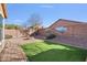 Large backyard area with desert landscaping, synthetic grass and a fire pit at 2009 E Lindrick Dr, Gilbert, AZ 85298