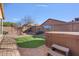 A lush backyard with desert landscaping, synthetic grass and a hot tub at 2009 E Lindrick Dr, Gilbert, AZ 85298