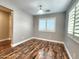 Bedroom with wood-look floors and bright, shuttered windows at 2009 E Lindrick Dr, Gilbert, AZ 85298