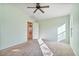 A light green bedroom with carpet floors and an open door to the dining room at 2009 E Lindrick Dr, Gilbert, AZ 85298