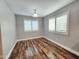 Bedroom with wood-look floors and bright, shuttered windows at 2009 E Lindrick Dr, Gilbert, AZ 85298