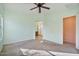 A light green bedroom with carpet floors and access to the bathroom at 2009 E Lindrick Dr, Gilbert, AZ 85298