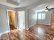 Bonus room with laminate wood floors and shuttered windows connects to a bathroom at 2009 E Lindrick Dr, Gilbert, AZ 85298