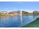 Scenic view of the community lake featuring a fountain with mountain views at 2009 E Lindrick Dr, Gilbert, AZ 85298