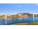 Picturesque community lake with dual fountains and beautiful mountain views in the background at 2009 E Lindrick Dr, Gilbert, AZ 85298