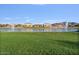 Scenic view of the community pond, surrounded by lush green grass at 2009 E Lindrick Dr, Gilbert, AZ 85298