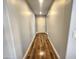 Hallway view featuring beautiful wood-look flooring that leads to a white front door at 2009 E Lindrick Dr, Gilbert, AZ 85298