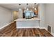 Open-concept kitchen featuring wood cabinets, quartz counters, and stainless steel appliances at 2009 E Lindrick Dr, Gilbert, AZ 85298