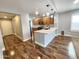Open-concept kitchen featuring wood cabinets, quartz counters, and stainless steel appliances at 2009 E Lindrick Dr, Gilbert, AZ 85298
