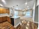 Open-concept kitchen with wood cabinets, quartz counters, and stainless steel appliances at 2009 E Lindrick Dr, Gilbert, AZ 85298