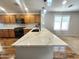 Modern kitchen featuring a large center island with a white countertop and wood cabinets at 2009 E Lindrick Dr, Gilbert, AZ 85298