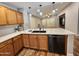 Bright, open kitchen with wooden cabinets, light countertops, and modern appliances for the home chef at 2009 E Lindrick Dr, Gilbert, AZ 85298