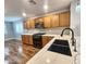 Modern kitchen featuring white quartz countertops, dark hardware, and stainless steel appliances at 2009 E Lindrick Dr, Gilbert, AZ 85298