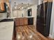 Well-appointed kitchen featuring stainless steel appliances, wood cabinetry and stylish pendant lighting at 2009 E Lindrick Dr, Gilbert, AZ 85298