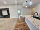 Open floor plan showcasing a kitchen with marble countertops adjacent to a living room with a custom entertainment center at 2009 E Lindrick Dr, Gilbert, AZ 85298