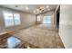 Spacious living room features neutral carpeting, vaulted ceilings, and a sliding glass door to the backyard at 2009 E Lindrick Dr, Gilbert, AZ 85298