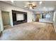 Open-concept living room showcases a custom entertainment center, neutral colors, and easy access to the kitchen at 2009 E Lindrick Dr, Gilbert, AZ 85298