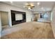 Expansive living room with integrated entertainment center, neutral carpeting, and an open layout to the kitchen at 2009 E Lindrick Dr, Gilbert, AZ 85298