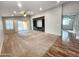 Large living room boasts neutral carpeting, sliding glass door, and a custom entertainment center at 2009 E Lindrick Dr, Gilbert, AZ 85298