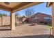 Covered patio area with desert landscaping and a painted block wall at 2009 E Lindrick Dr, Gilbert, AZ 85298