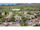 An aerial view shows a pool in a residential community with mountains and blue skies in the background at 20100 N 78Th Pl # 2210, Scottsdale, AZ 85255