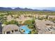 Expansive aerial view of a community with a sparkling pool and mountain backdrop at 20100 N 78Th Pl # 2210, Scottsdale, AZ 85255