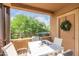 Cozy balcony with modern furniture and view of lush greenery and blue skies at 20100 N 78Th Pl # 2210, Scottsdale, AZ 85255