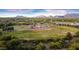 Aerial view of a baseball field complex surrounded by trees and distant mountains under a bright sky at 20100 N 78Th Pl # 2210, Scottsdale, AZ 85255
