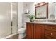 Bathroom features a walk-in shower, wooden vanity, and decorative mirror with accent lighting at 20100 N 78Th Pl # 2210, Scottsdale, AZ 85255