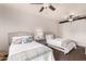 Bright bedroom featuring two beds, ceiling fan, and stylish decor at 20100 N 78Th Pl # 2210, Scottsdale, AZ 85255