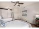 Bright bedroom featuring two beds, ceiling fan, barn door, and stylish decor at 20100 N 78Th Pl # 2210, Scottsdale, AZ 85255