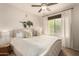 Bedroom with a plush bed, ceiling fan, large window, and stylish decor for relaxation at 20100 N 78Th Pl # 2210, Scottsdale, AZ 85255
