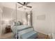 Bright bedroom featuring a four-poster bed, ceiling fan, and stylish decor at 20100 N 78Th Pl # 2210, Scottsdale, AZ 85255