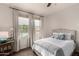 Bright bedroom featuring a bed with a view of the pool outside at 20100 N 78Th Pl # 2210, Scottsdale, AZ 85255