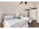 Bright bedroom featuring two beds, ceiling fan, barn door, and stylish decor at 20100 N 78Th Pl # 2210, Scottsdale, AZ 85255