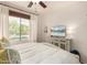 Bedroom featuring a large window with a view of the community pool, ceiling fan and TV at 20100 N 78Th Pl # 2210, Scottsdale, AZ 85255