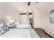 Bright bedroom featuring two beds, ceiling fan, barn door, and stylish decor at 20100 N 78Th Pl # 2210, Scottsdale, AZ 85255