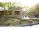 Clubhouse with elegant stone facade, water feature, and lush landscaping at 20100 N 78Th Pl # 2210, Scottsdale, AZ 85255
