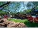 Charming community area with a serene waterfall, a striking statue, and inviting red rocking chairs at 20100 N 78Th Pl # 2210, Scottsdale, AZ 85255