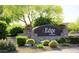 Landscaped community sign featuring a stone base and colorful desert plants, including cacti and flowers at 20100 N 78Th Pl # 2210, Scottsdale, AZ 85255