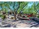 Beautifully landscaped community area with lush trees, rock formations, and cozy seating for residents at 20100 N 78Th Pl # 2210, Scottsdale, AZ 85255